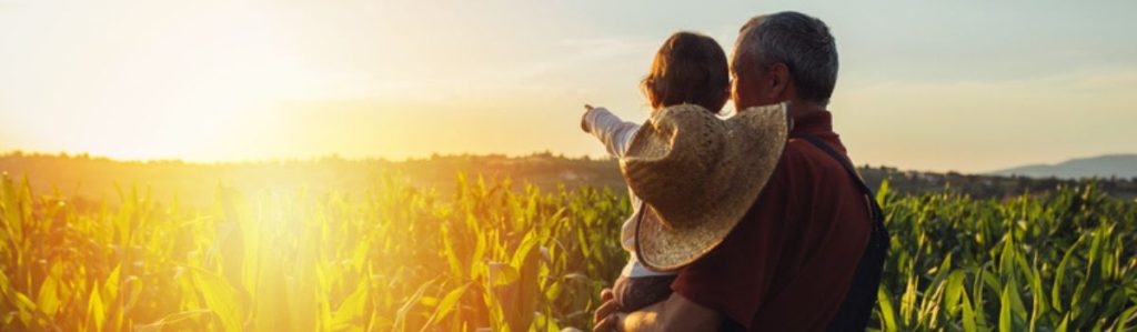 Succession planning farmer with his child viewing his farm